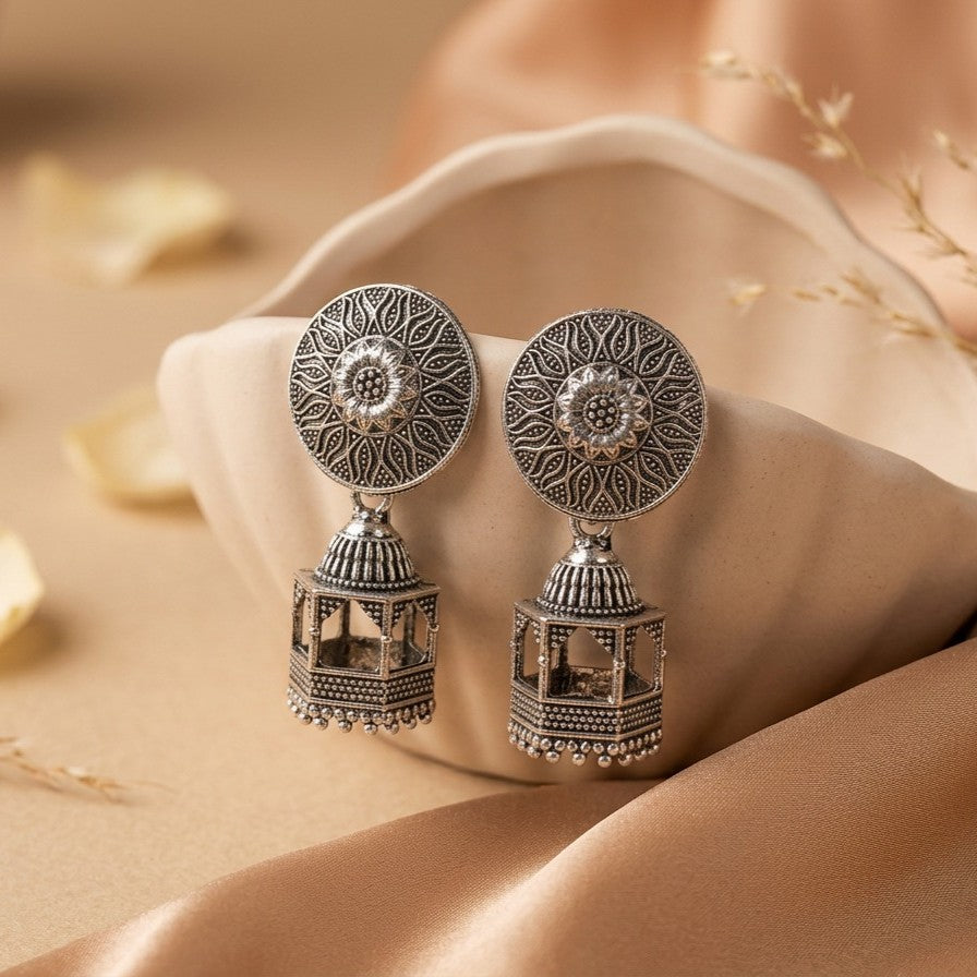 A statement of refined elegance with a hint of royal charm, this piece captures the beauty of intricate detailing and cascading movement in a truly graceful form. The ornate stud flows into delicate layered drops, creating a silhouette that feels both regal and mesmerizing with every motion.