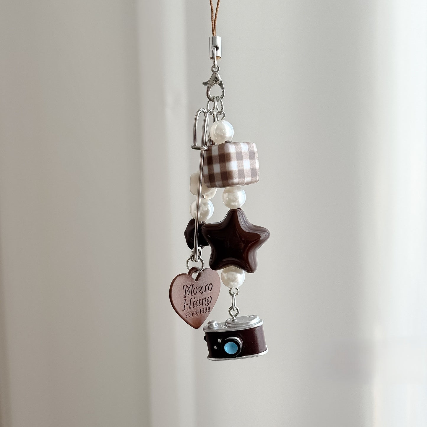 A little story you can carry everywhere — warm, nostalgic, and softly detailed. The Mocha Diary Charm blends cozy café tones with playful elements, creating a charming piece that feels both aesthetic and personal, like a memory captured in miniature.