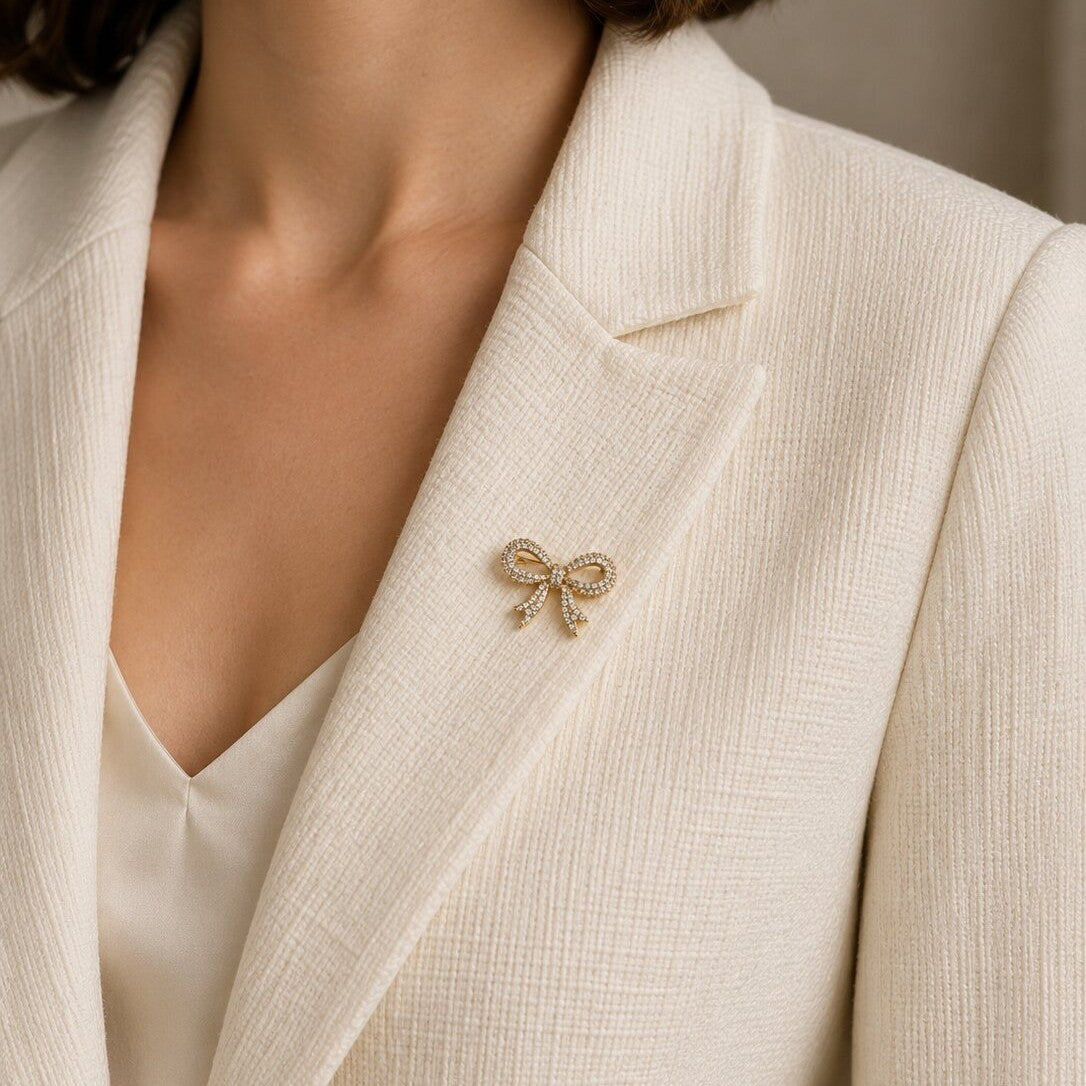 Like a delicate ribbon tied around the sweetest little secret, this charming brooch captures a dreamy blend of coquette elegance, feminine sparkle, and graceful romance. Featuring a beautifully sculpted bow silhouette covered in shimmering crystal accents, it creates an enchanting statement that feels playful, polished, and effortlessly luxurious.