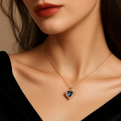 Necklace with a heart-shaped blue gemstone pendant on a model against a neutral background