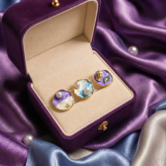 A collection of miniature artworks wrapped into wearable elegance, these rings blend flowing enamel textures, soft pastel tones, pearls, and shell-inspired details into a dreamy statement design. Each variant carries its own oceanic and artistic charm while staying beautifully cohesive as one collection.
