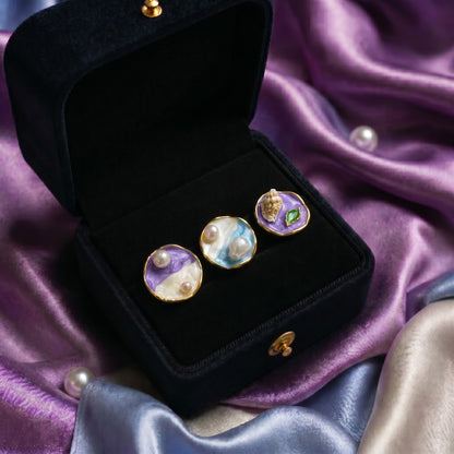 A collection of miniature artworks wrapped into wearable elegance, these rings blend flowing enamel textures, soft pastel tones, pearls, and shell-inspired details into a dreamy statement design. Each variant carries its own oceanic and artistic charm while staying beautifully cohesive as one collection.