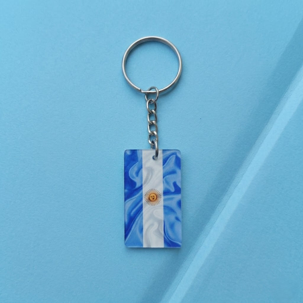 Like a small piece of Argentina’s football spirit carried everywhere, this stylish keychain captures a proud blend of national identity, sporting passion, and everyday practicality. Featuring the iconic sky blue and white flag design with the golden Sun of May, it creates a bold accessory that feels meaningful, distinctive, and effortlessly stylish.