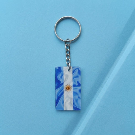 Like a small piece of Argentina’s football spirit carried everywhere, this stylish keychain captures a proud blend of national identity, sporting passion, and everyday practicality. Featuring the iconic sky blue and white flag design with the golden Sun of May, it creates a bold accessory that feels meaningful, distinctive, and effortlessly stylish.