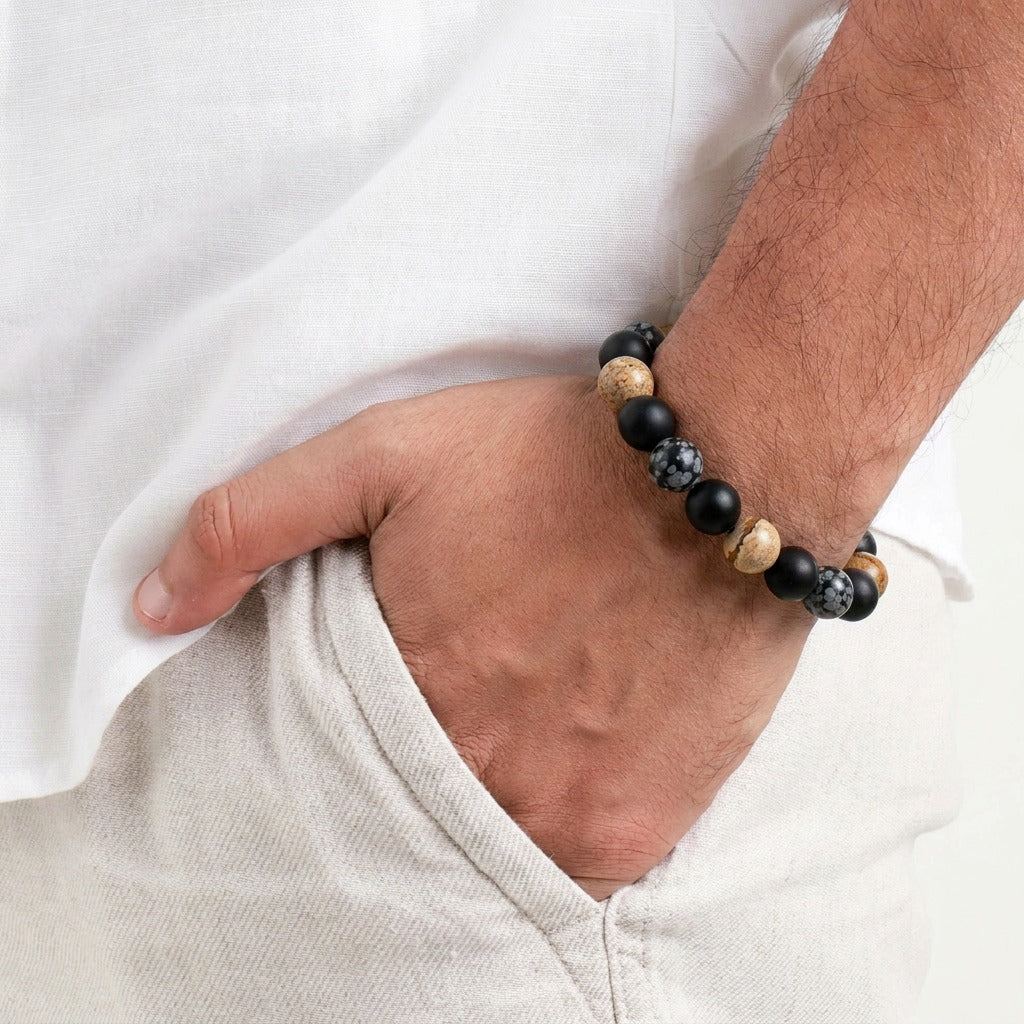 A grounded blend of strength and style, this bracelet brings together earthy tones and bold contrast in a clean, modern form. With its natural stone textures and matte black beads, it reflects a calm confidence that feels both timeless and effortlessly masculine.