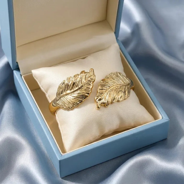 A graceful expression of nature and elegance, this cuff captures the beauty of golden feathers sculpted into a bold statement silhouette. With its textured detailing and flowing form, it evokes a sense of freedom, strength, and timeless sophistication.