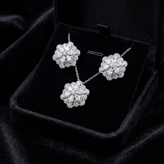 A delicate bloom captured in sparkle, the Blossom Radiance Set brings together floral elegance and luminous charm in a design that feels both graceful and radiant. Each shimmering petal reflects light beautifully, creating a soft glow that enhances your look with effortless femininity. Whether worn for a celebration or as a daily touch of elegance, this floral set adds a graceful sparkle to every moment.