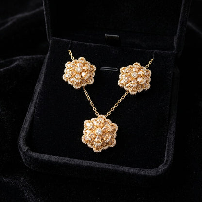 A delicate bloom captured in sparkle, the Blossom Radiance Set brings together floral elegance and luminous charm in a design that feels both graceful and radiant. Each shimmering petal reflects light beautifully, creating a soft glow that enhances your look with effortless femininity. Whether worn for a celebration or as a daily touch of elegance, this floral set adds a graceful sparkle to every moment.