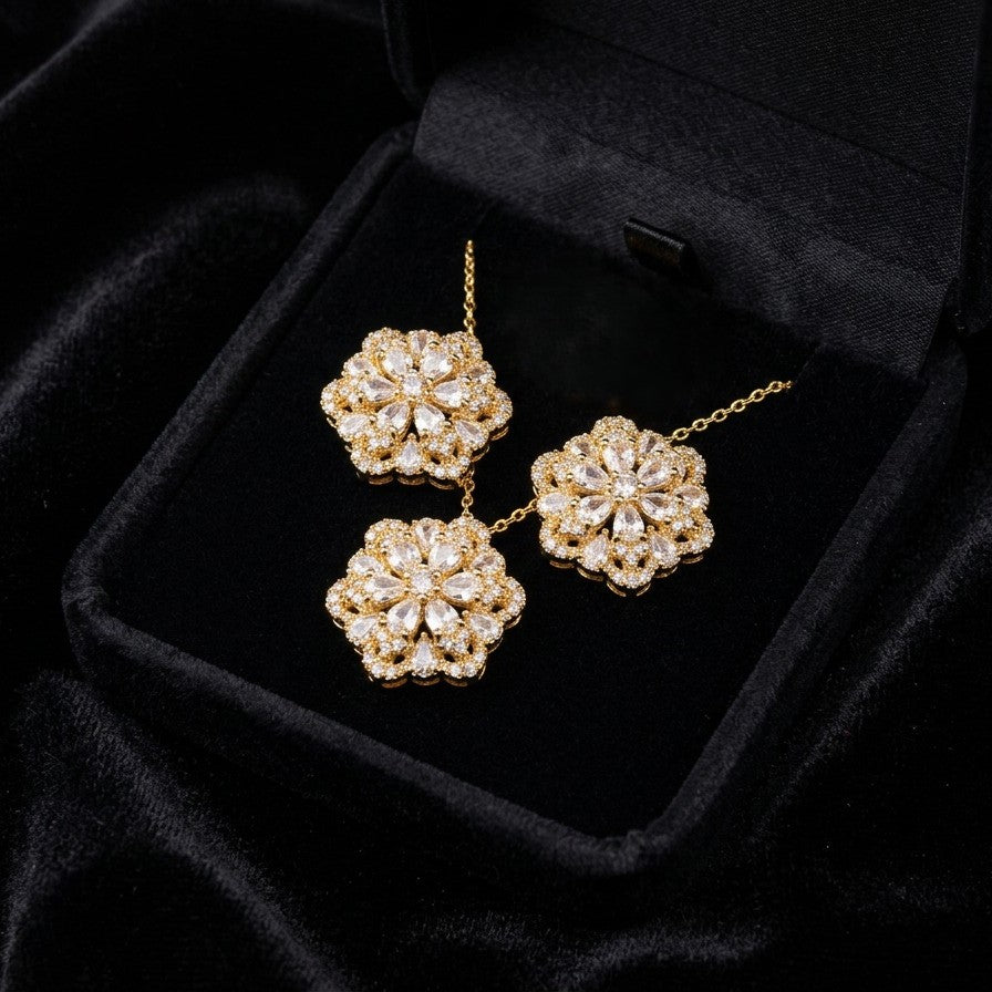 A delicate bloom captured in sparkle, the Blossom Radiance Set brings together floral elegance and luminous charm in a design that feels both graceful and radiant. Each shimmering petal reflects light beautifully, creating a soft glow that enhances your look with effortless femininity. Whether worn for a celebration or as a daily touch of elegance, this floral set adds a graceful sparkle to every moment.