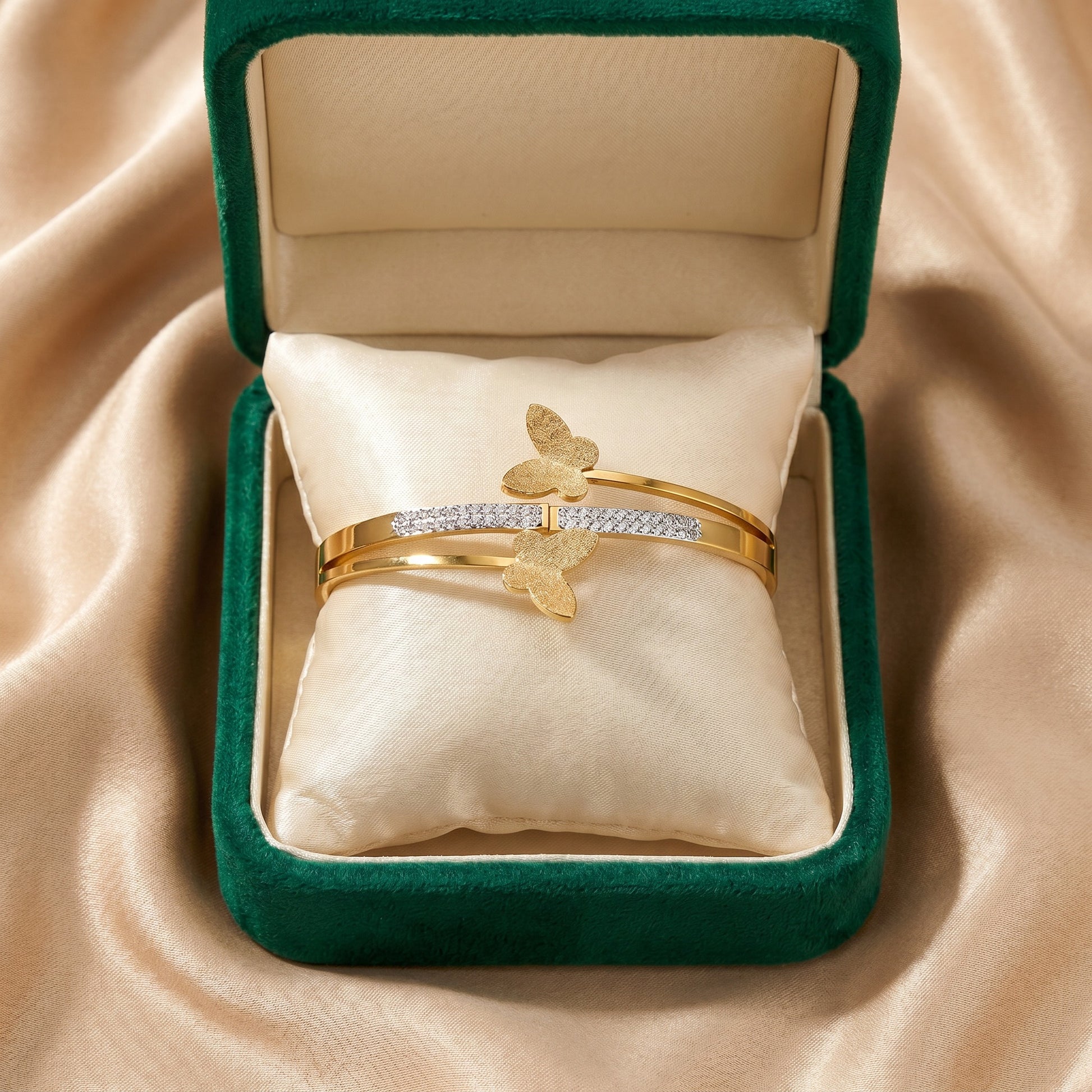 Like golden butterflies resting on a delicate vine, this elegant cuff captures a soft sense of movement, charm, and feminine beauty. Featuring butterfly motifs paired with a sparkling crystal-studded accent line, it creates a graceful statement that feels dreamy, refined, and effortlessly luxurious.