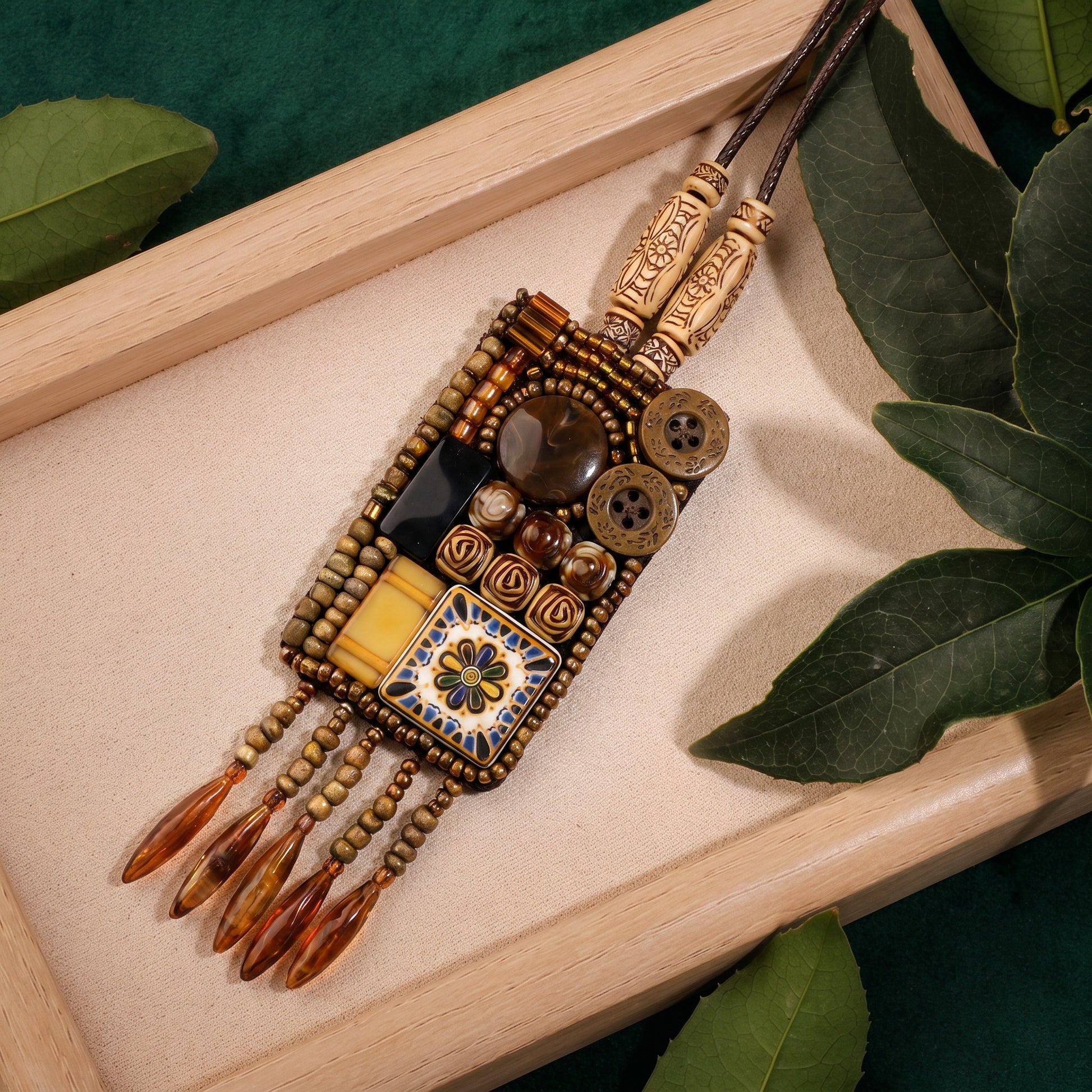 A handcrafted melody of earthy textures and old-world charm, this necklace features mosaic-inspired details, antique accents, and dangling beadwork that feels rich with character. Its artisan silhouette carries a warm bohemian spirit, like a little treasure found along a desert caravan trail.