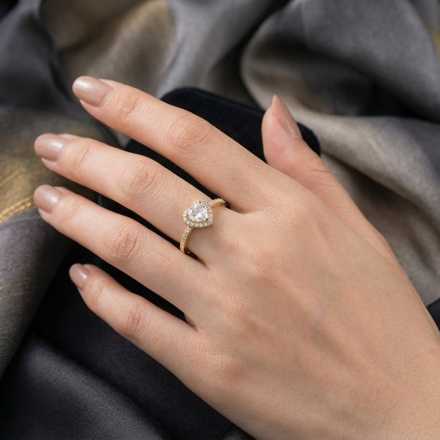 Celestia Love Ring captures the beauty of love in its most delicate form a shimmering heart adorned with brilliant zircon stones. Designed in both golden and silver variants, this ring blends timeless elegance with a soft romantic glow. Its refined band and luminous centerpiece create a graceful balance, making it a piece that feels effortlessly beautiful for every moment.