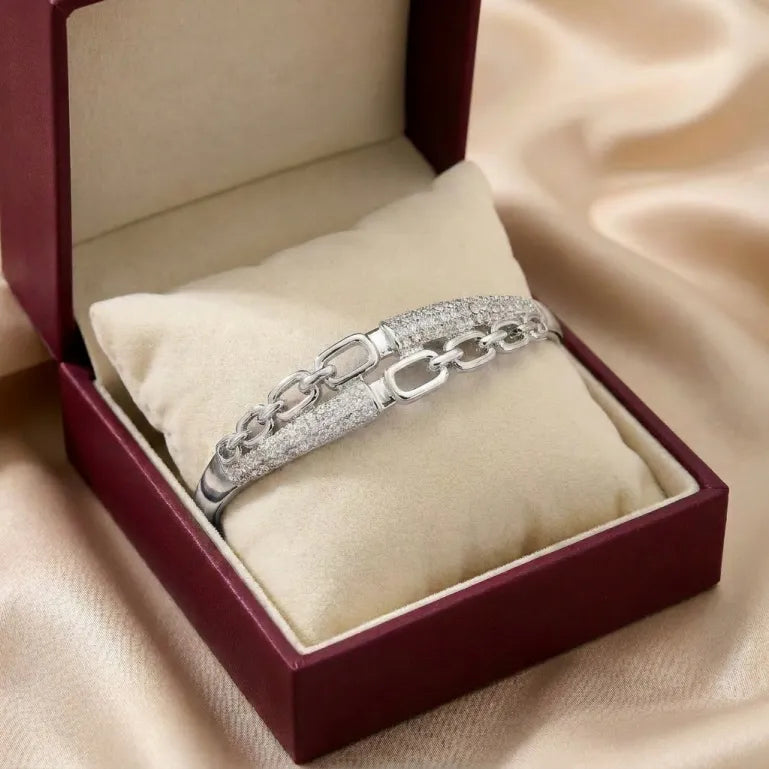 A bold chain silhouette softened with crystal elegance, this bracelet captures the beauty of modern links wrapped in a polished luxury finish. With its open-link design and shimmering pavé details, it creates a refined statement that feels stylish, premium, and effortlessly confident. 