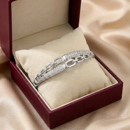 A bold chain silhouette softened with crystal elegance, this bracelet captures the beauty of modern links wrapped in a polished luxury finish. With its open-link design and shimmering pavé details, it creates a refined statement that feels stylish, premium, and effortlessly confident. 
