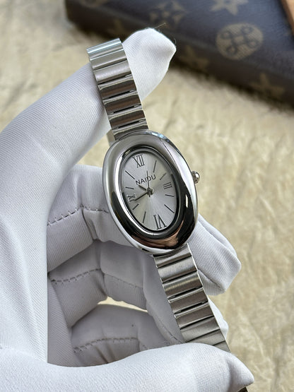 A refined oval dial wrapped in a smooth silver frame, designed to move effortlessly with your everyday moments. Minimal yet expressive, this watch brings quiet luxury to every wrist — perfect for daily wear or thoughtful gifting.