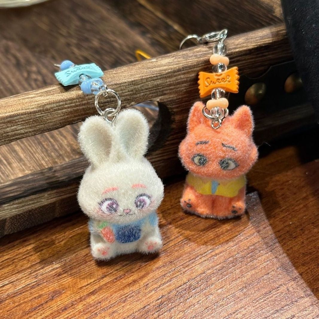 A playful blend of charm and comfort, this piece brings soft character detailing together with a cozy, handcrafted feel. Designed to add a touch of personality to your everyday essentials, it turns something simple into a cute, eye-catching statement.