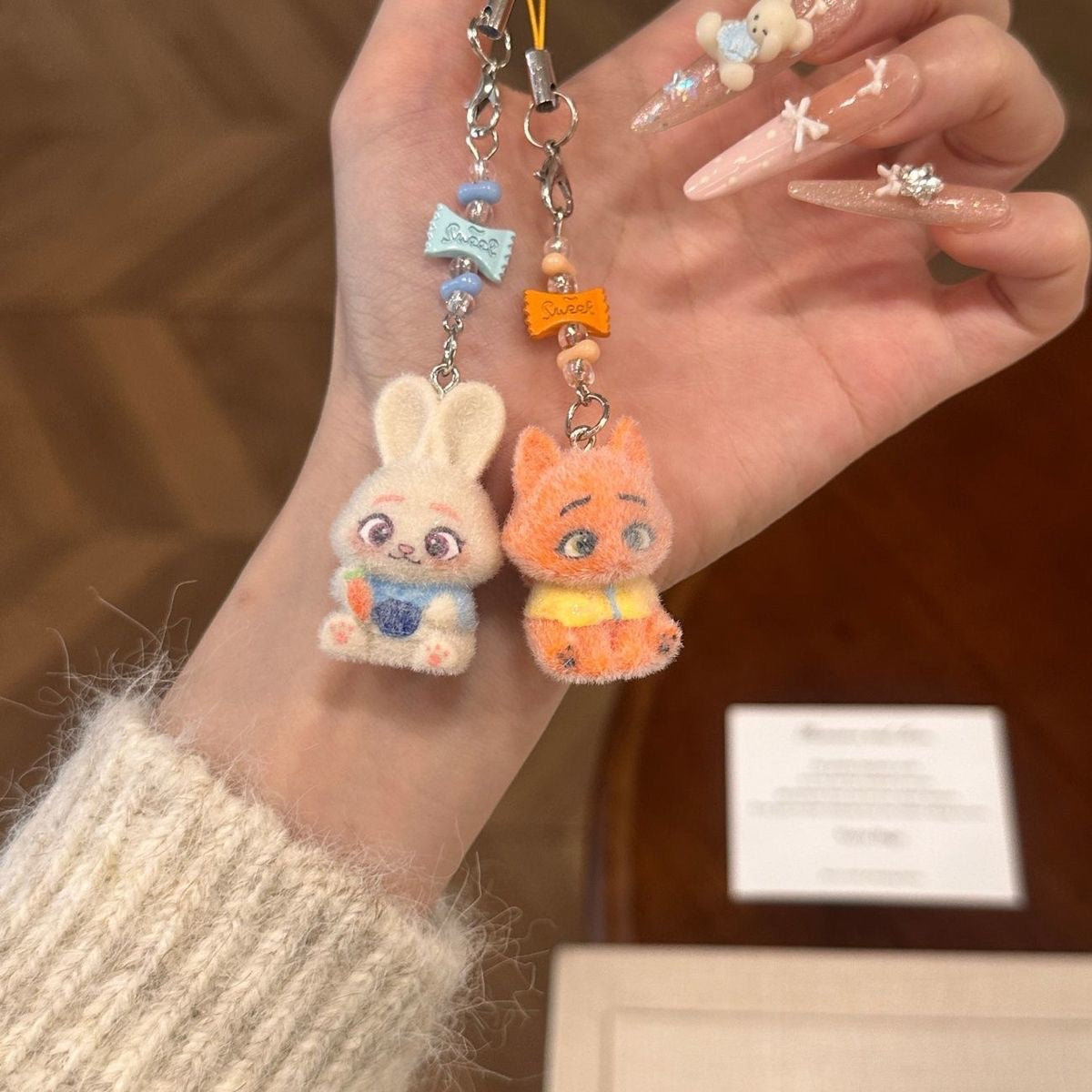 A playful blend of charm and comfort, this piece brings soft character detailing together with a cozy, handcrafted feel. Designed to add a touch of personality to your everyday essentials, it turns something simple into a cute, eye-catching statement.