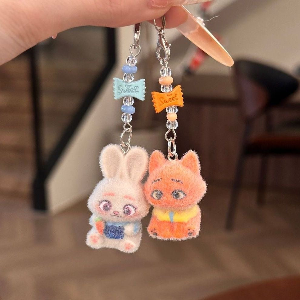 A playful blend of charm and comfort, this piece brings soft character detailing together with a cozy, handcrafted feel. Designed to add a touch of personality to your everyday essentials, it turns something simple into a cute, eye-catching statement.