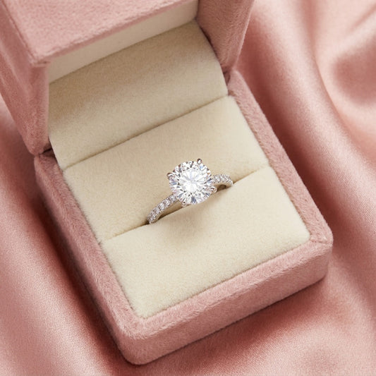 A timeless sparkle wrapped in delicate elegance, this ring captures the beauty of a radiant crystal softly veiled in light. With its graceful solitaire silhouette and shimmering pavé band, it creates a refined brilliance that feels elegant, romantic, and effortlessly luxurious.
