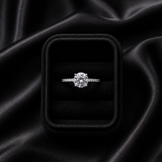 A timeless sparkle wrapped in delicate elegance, this ring captures the beauty of a radiant crystal softly veiled in light. With its graceful solitaire silhouette and shimmering pavé band, it creates a refined brilliance that feels elegant, romantic, and effortlessly luxurious.
