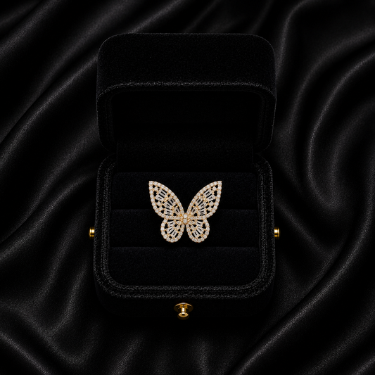 A delicate butterfly frozen in crystal shimmer, this ring captures the beauty of graceful wings touched by light. With its intricate openwork details and sparkling silhouette, it brings a soft yet statement elegance that feels dreamy, feminine, and effortlessly enchanting.