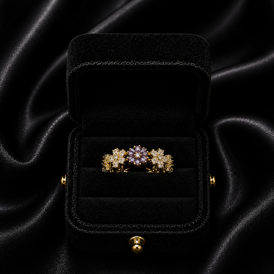 A delicate bloom of shimmering petals, this ring captures the soft elegance of tiny daisies frozen in crystal light. Designed with sparkling floral details and a graceful open silhouette, it brings a dreamy charm that feels both feminine and timeless.