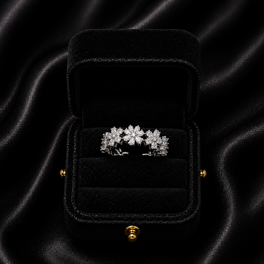 A delicate bloom of shimmering petals, this ring captures the soft elegance of tiny daisies frozen in crystal light. Designed with sparkling floral details and a graceful open silhouette, it brings a dreamy charm that feels both feminine and timeless.