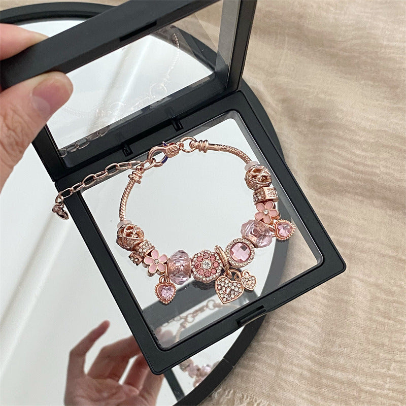 A romantic rose-gold or dreamy lilac,&nbsp;these bracelets are defined by a&nbsp;crystal center and a heart-and dream catcher-flower charm frame. The Dreamveil Charm Bracelets feel like a soft fairytale on your wrist—sweet sparkle, delicate details, and that “gifted with love” kind of glow.

