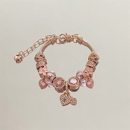 A romantic rose-gold or dreamy lilac,&nbsp;these bracelets are defined by a&nbsp;crystal center and a heart-and dream catcher-flower charm frame. The Dreamveil Charm Bracelets feel like a soft fairytale on your wrist—sweet sparkle, delicate details, and that “gifted with love” kind of glow.

