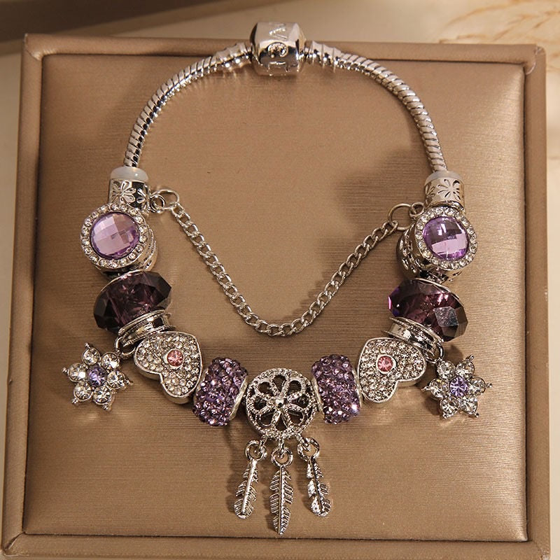 A romantic rose-gold or dreamy lilac,&nbsp;these bracelets are defined by a&nbsp;crystal center and a heart-and dream catcher-flower charm frame. The Dreamveil Charm Bracelets feel like a soft fairytale on your wrist—sweet sparkle, delicate details, and that “gifted with love” kind of glow.

