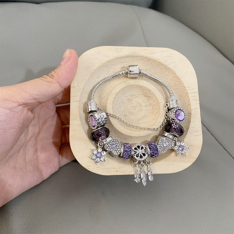 A romantic rose-gold or dreamy lilac,&nbsp;these bracelets are defined by a&nbsp;crystal center and a heart-and dream catcher-flower charm frame. The Dreamveil Charm Bracelets feel like a soft fairytale on your wrist—sweet sparkle, delicate details, and that “gifted with love” kind of glow.

