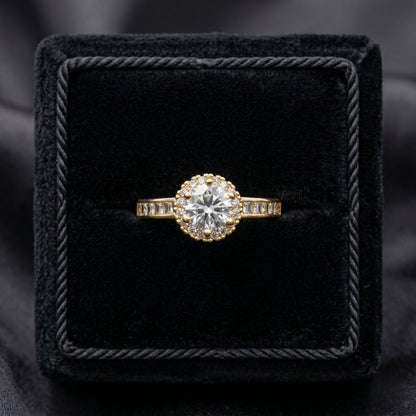 Elyra Spark Ring is a graceful blend of brilliance and simplicity, featuring a radiant zircon centerpiece surrounded by a fine halo of shimmering stones. Its sleek band, accented with subtle crystal detailing, enhances the overall sparkle while maintaining an elegant, minimal look. Designed to shine effortlessly, this ring adds a refined glow to both everyday moments and special occasions.