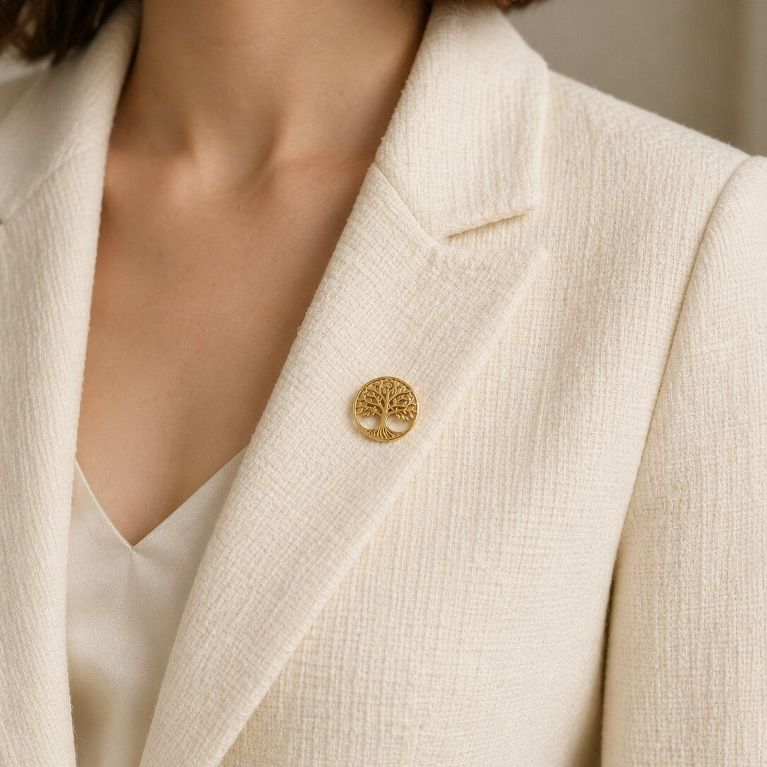 Like an ancient tree growing through generations, this elegant brooch captures a beautiful sense of strength, connection, and timeless growth. Featuring an intricate tree silhouette enclosed within a polished circular frame, it creates a meaningful statement that feels graceful, symbolic, and effortlessly luxurious.