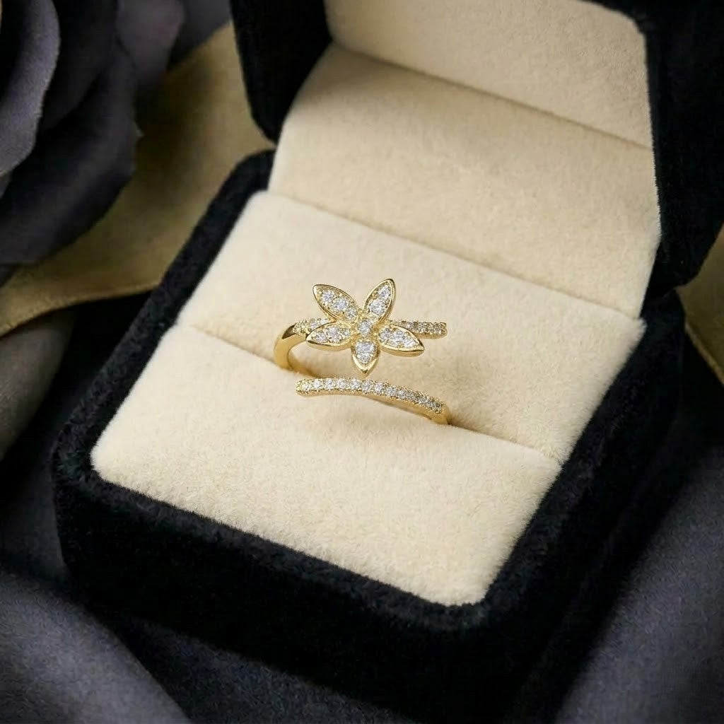A radiant bloom captured in delicate brilliance, this ring features a sparkling floral silhouette paired with a graceful split pavé band. Its petal-inspired design creates a soft luminous charm that feels elegant, feminine, and enchanting.