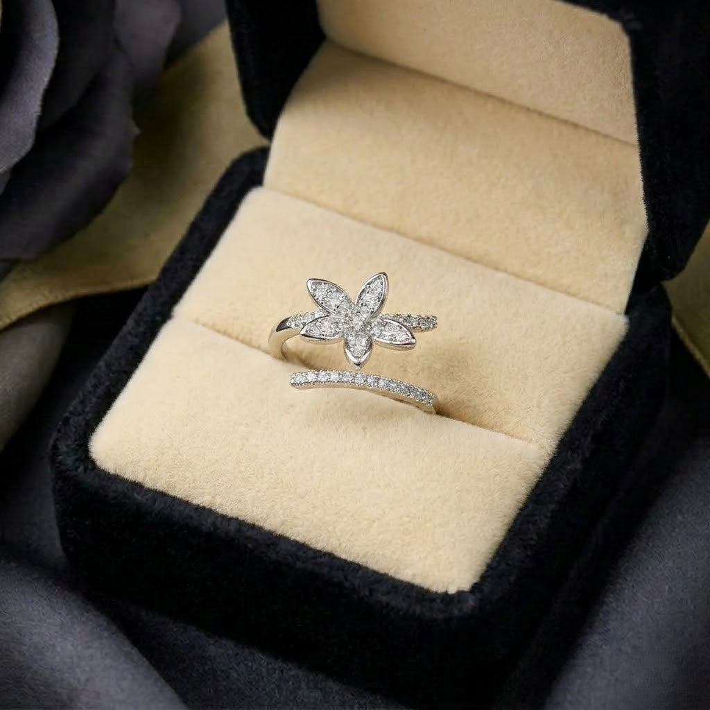 A radiant bloom captured in delicate brilliance, this ring features a sparkling floral silhouette paired with a graceful split pavé band. Its petal-inspired design creates a soft luminous charm that feels elegant, feminine, and enchanting.