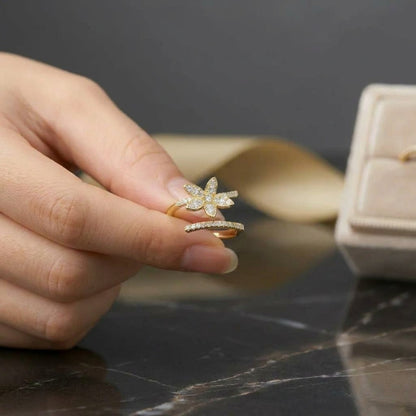 A radiant bloom captured in delicate brilliance, this ring features a sparkling floral silhouette paired with a graceful split pavé band. Its petal-inspired design creates a soft luminous charm that feels elegant, feminine, and enchanting.
