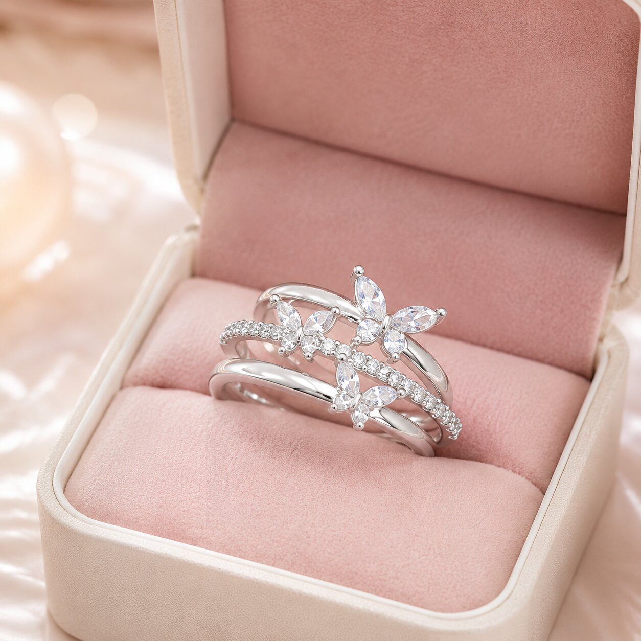 Like butterflies dancing through a sparkling cascade, this elegant ring captures a beautiful sense of freedom, movement, and delicate femininity. Featuring graceful butterfly motifs arranged across flowing crystal-studded bands, it creates a radiant statement that feels enchanting, refined, and effortlessly luxurious
