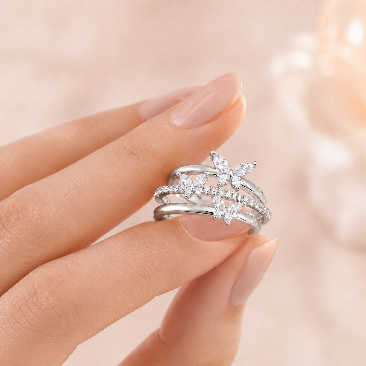Like butterflies dancing through a sparkling cascade, this elegant ring captures a beautiful sense of freedom, movement, and delicate femininity. Featuring graceful butterfly motifs arranged across flowing crystal-studded bands, it creates a radiant statement that feels enchanting, refined, and effortlessly luxurious