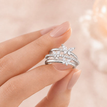 Like butterflies dancing through a sparkling cascade, this elegant ring captures a beautiful sense of freedom, movement, and delicate femininity. Featuring graceful butterfly motifs arranged across flowing crystal-studded bands, it creates a radiant statement that feels enchanting, refined, and effortlessly luxurious