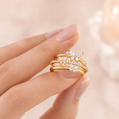 Like butterflies dancing through a sparkling cascade, this elegant ring captures a beautiful sense of freedom, movement, and delicate femininity. Featuring graceful butterfly motifs arranged across flowing crystal-studded bands, it creates a radiant statement that feels enchanting, refined, and effortlessly luxurious
