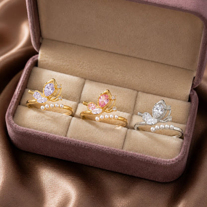 A delicate butterfly kissed with pearl elegance, this ring features a graceful wing-inspired centerpiece floating above a soft row of luminous pearls. Its dreamy crystal details and airy silhouette create a charming look that feels feminine, elegant, and beautifully whimsical.