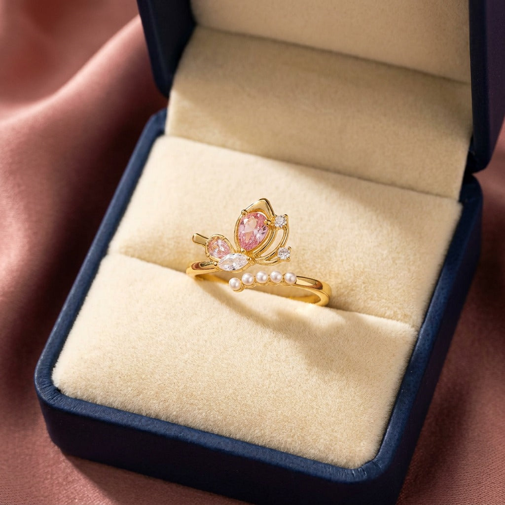 A delicate butterfly kissed with pearl elegance, this ring features a graceful wing-inspired centerpiece floating above a soft row of luminous pearls. Its dreamy crystal details and airy silhouette create a charming look that feels feminine, elegant, and beautifully whimsical.