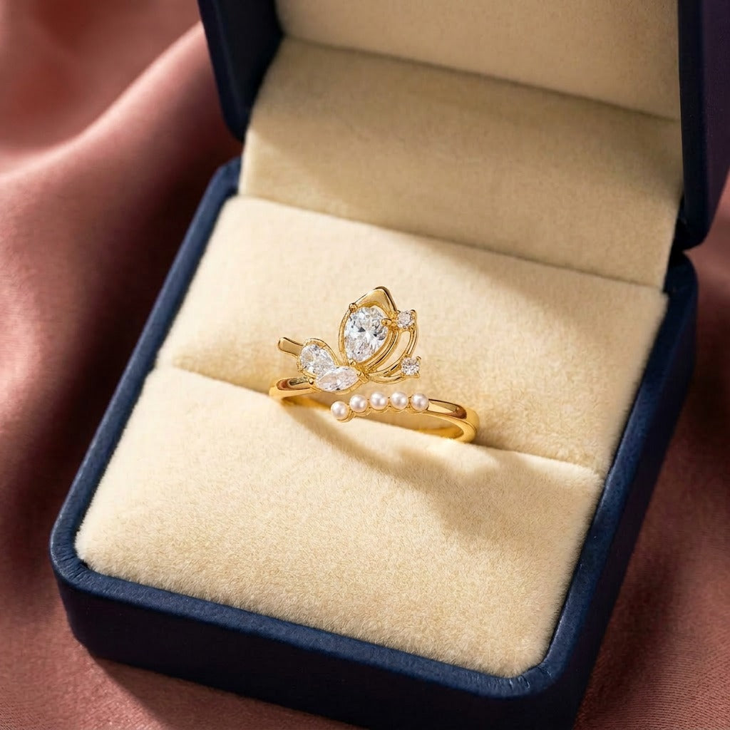 A delicate butterfly kissed with pearl elegance, this ring features a graceful wing-inspired centerpiece floating above a soft row of luminous pearls. Its dreamy crystal details and airy silhouette create a charming look that feels feminine, elegant, and beautifully whimsical.