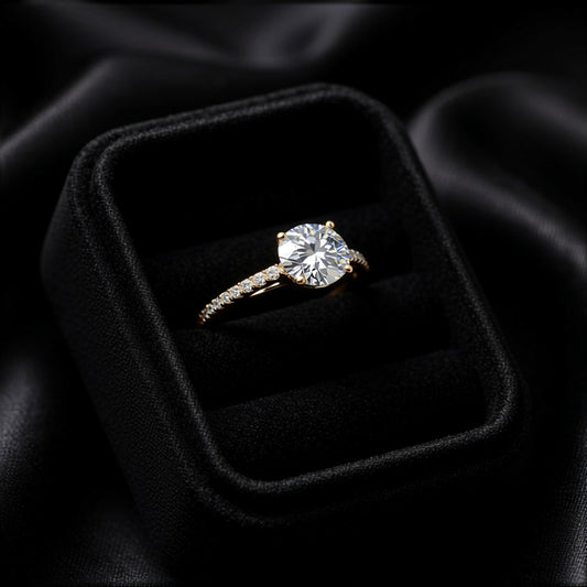 A timeless sparkle wrapped in delicate elegance, this ring captures the beauty of a radiant crystal softly veiled in light. With its graceful solitaire silhouette and shimmering pavé band, it creates a refined brilliance that feels elegant, romantic, and effortlessly luxurious.
