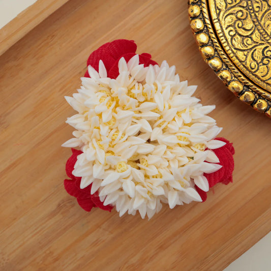 Inspired by the charm of traditional floral adornments, the Gulbahar Floral Gajra beautifully captures the elegance of fresh jasmine and rose garlands in a long-lasting artificial form. The delicate white blossoms paired with soft red floral accents create a graceful and festive look — perfect for enhancing your hairstyle or wrist looks which with a touch of classic beauty or can wear as a bracelet.