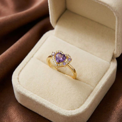 A radiant symbol of love wrapped in brilliance, this ring features a heart-cut centerpiece embraced by a sparkling halo of crystal accents. Available in Crystal White, Royal Violet, and Blush Pink variants, its romantic silhouette creates a timeless charm that feels elegant, feminine, and full of sparkle.