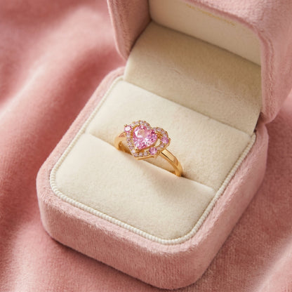 A radiant symbol of love wrapped in brilliance, this ring features a heart-cut centerpiece embraced by a sparkling halo of crystal accents. Available in Crystal White, Royal Violet, and Blush Pink variants, its romantic silhouette creates a timeless charm that feels elegant, feminine, and full of sparkle.