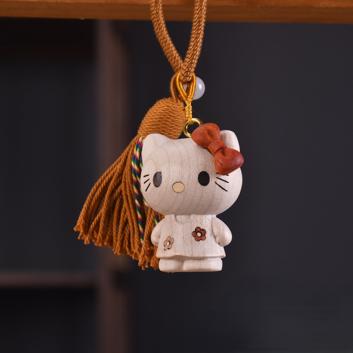 A tiny bundle of cuteness crafted with a soft handcrafted touch, this wooden kitty charm brings warmth, nostalgia, and a playful charm to your everyday essentials. The delicate tassel detail and smooth finish make it feel both cozy and uniquely stylish.