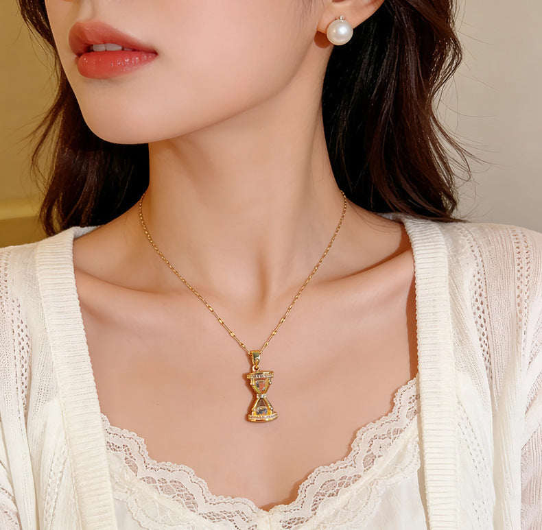 Premium Hourglass Lumina Necklace from Loftique BD: High-grade titanium steel hourglass pendant necklace encrusted with brilliant zircon stones. Available in Aurum Hour gold and Forest Hour silver finishes. The best gift for her and a perfect for gifting choice for milestone anniversaries, birthdays, or long-distance relationships in Bangladesh. Shop this exclusive one-stop gifting solution at the top-rated gift shop in BD, available only at Loftique.