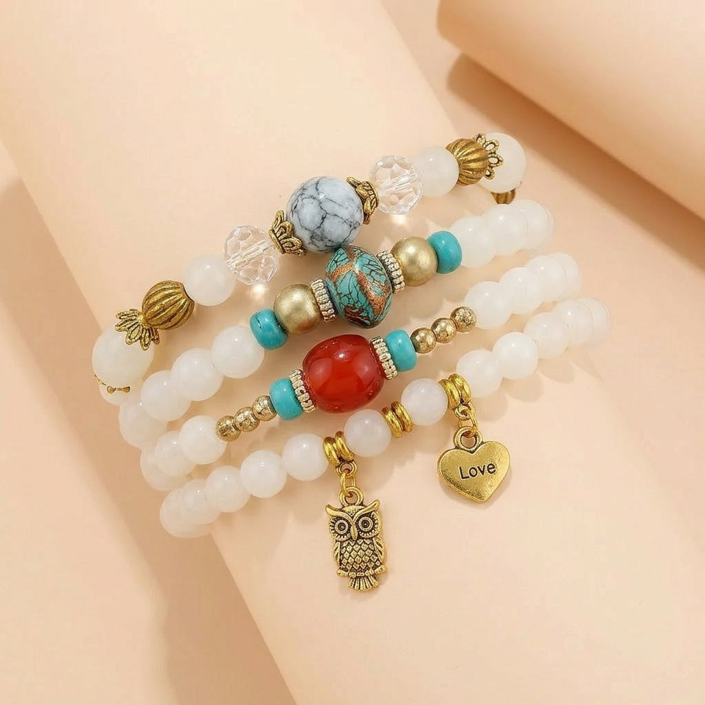 A graceful blend of soft ivory tones, vintage-inspired accents, and meaningful charms, this bracelet brings together elegance and whimsy in a beautifully layered design. Featuring delicate white beads, turquoise-inspired details, and symbolic charms, it creates a timeless look that feels both dreamy and distinctive.